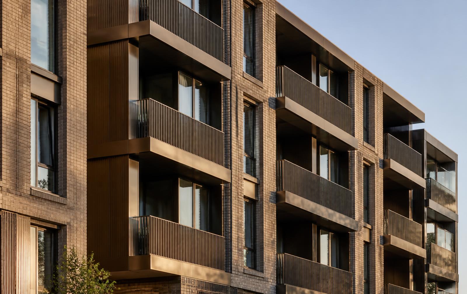 Contemporary residential facade in brick and bronze